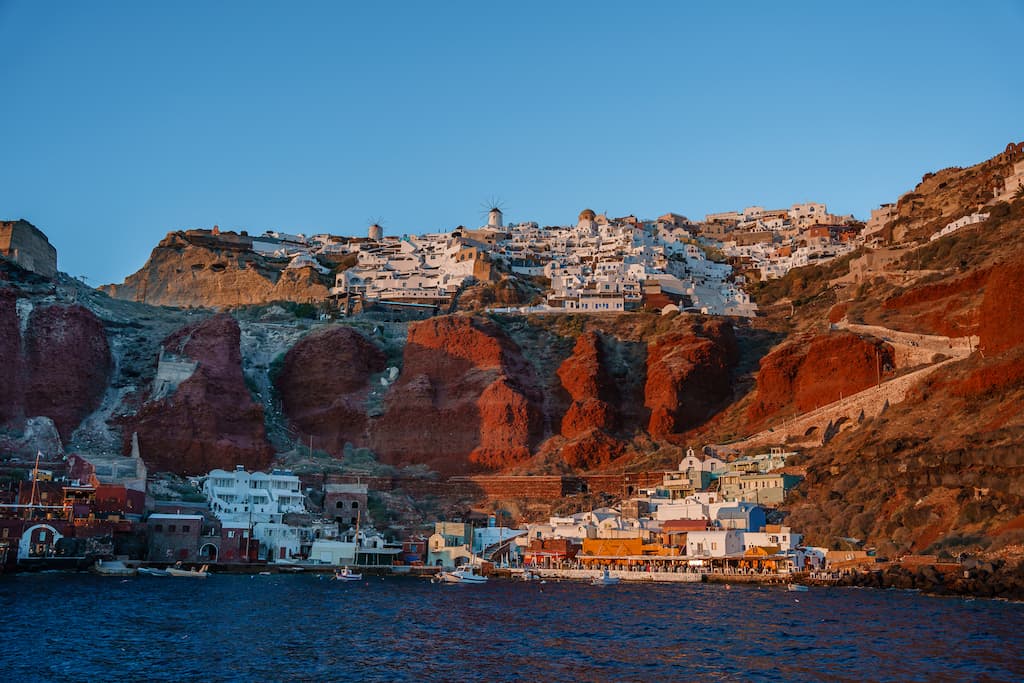 Best Santorini sunset cruises end in Amoudi Bay, just below Oia for sunset.