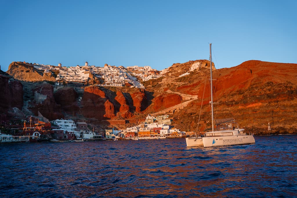 Best sunset cruises in Santorini end in Amoudi Bay to watch the famed Santorini sunset. 